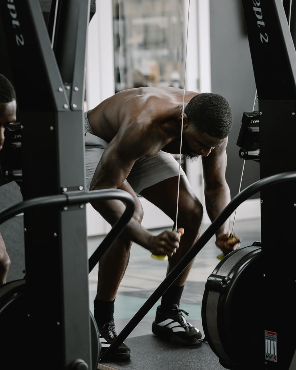 Athlete bent over recovering after an all-out erg effort