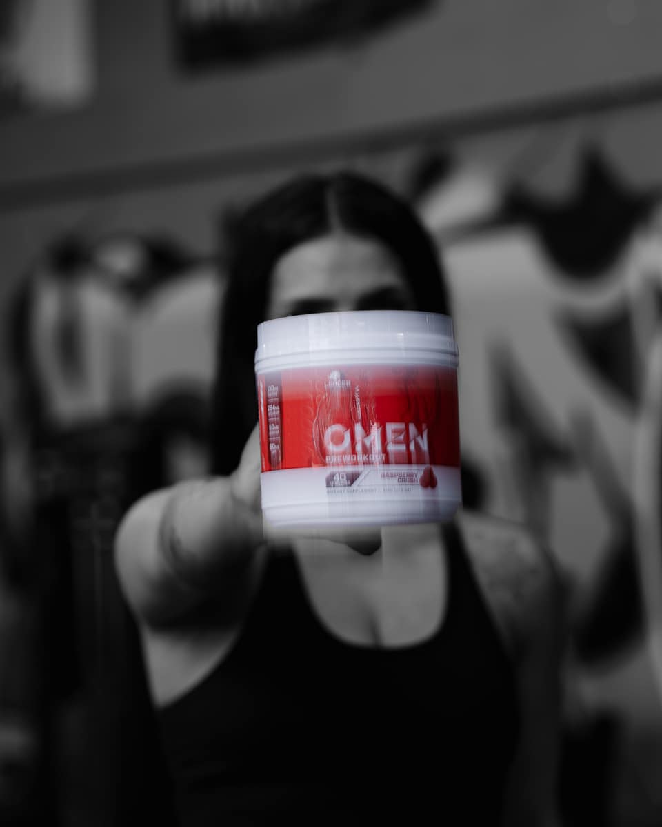 Black and white portrait of an athlete holding the OMEN tub to camera